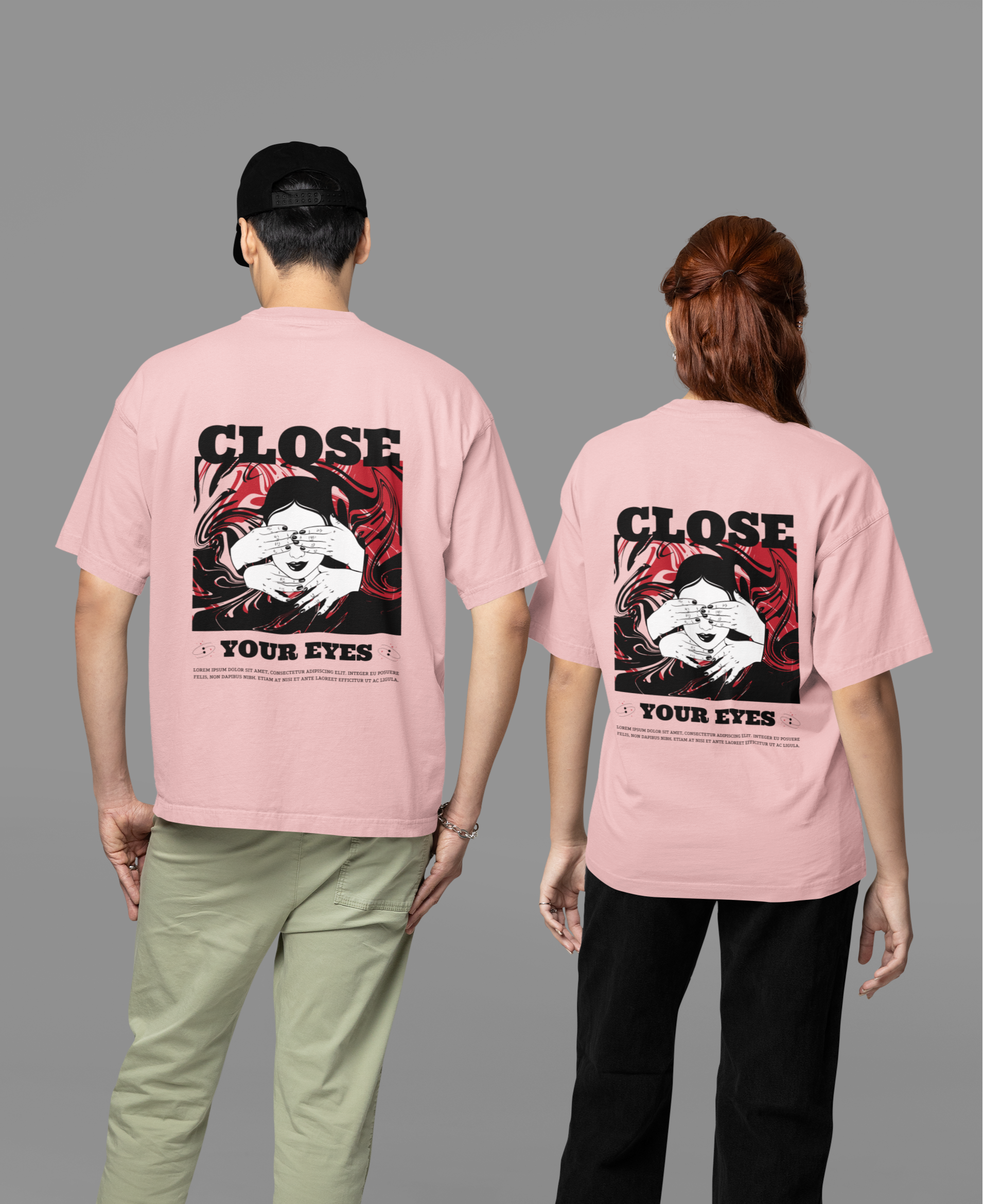 A man and woman wearing matching pink oversized T-shirts featuring the 'Close Your Eyes' painting design on the back, showcasing bold and artistic streetwear style.