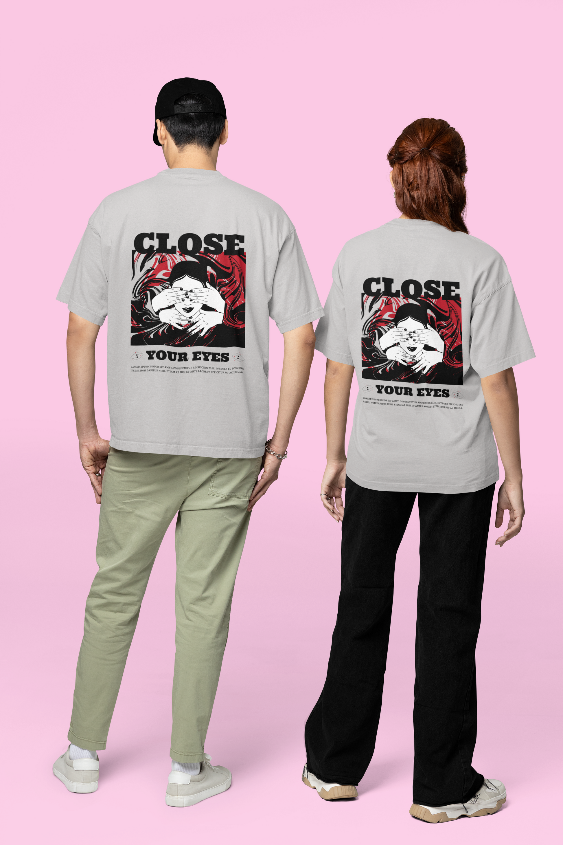 A man and woman wearing matching grey oversized T-shirts featuring the 'Close Your Eyes' painting design on the back, showcasing bold and artistic streetwear style perfect for modern urban fashion.