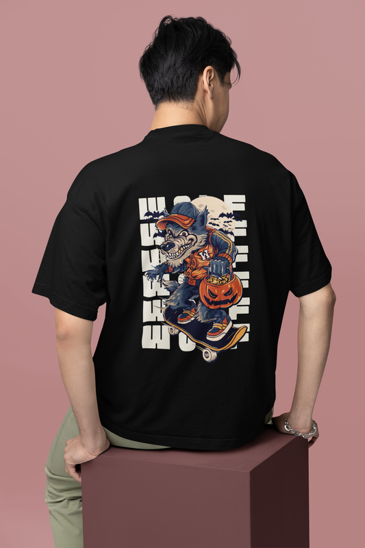 A solo man wearing a black oversized T-shirt with bold 'Believer' typography printed across the back, showcasing a confident and edgy streetwear style