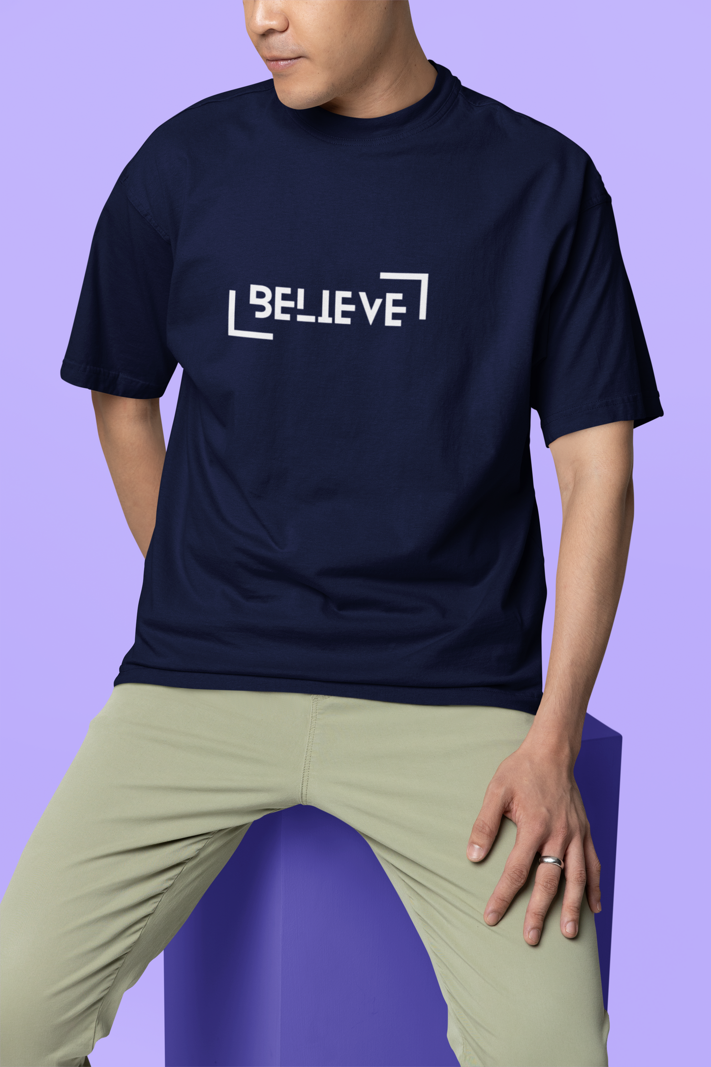 A solo man wearing a navy blue oversized T-shirt with a clean and simple front design, blending comfort and style effortlessly.