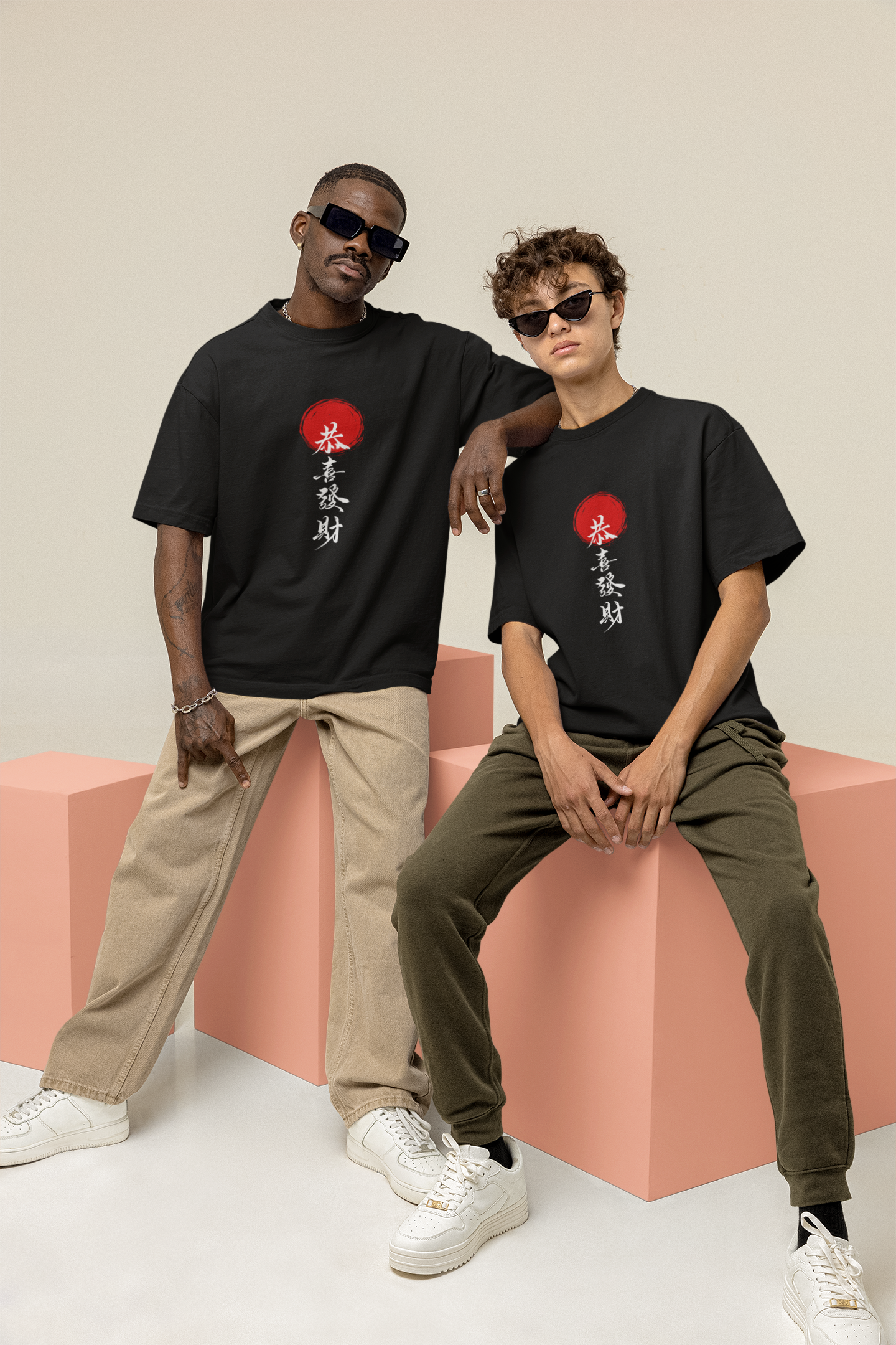Two men in matching black oversized T-shirts with intricate Chinese typography on the front, creating a bold and stylish streetwear statement.