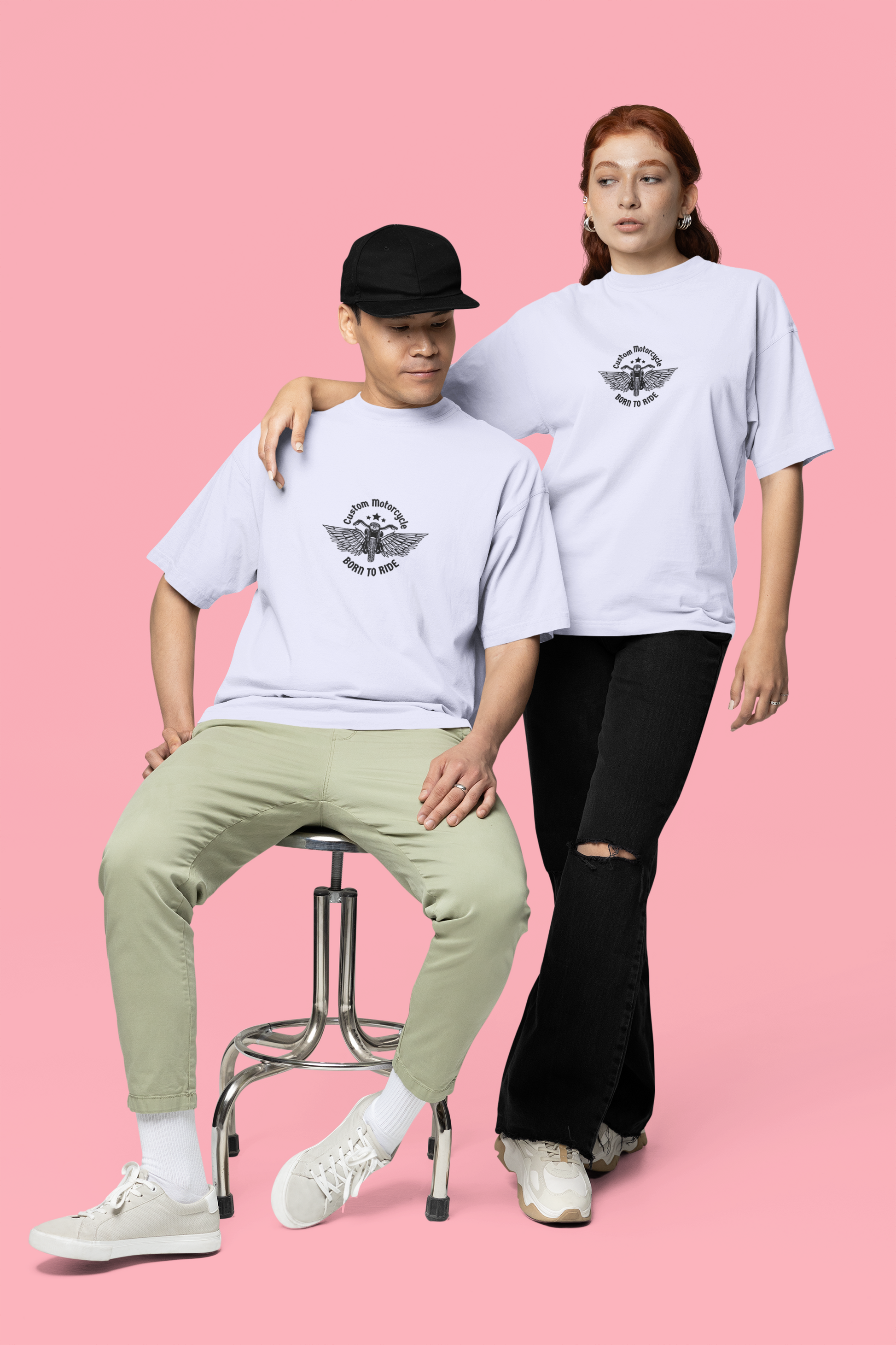 A man and woman in matching lavender oversized T-shirts featuring the bold 'Born to Ride' quote on the front, ideal for motorbike enthusiasts and streetwear lovers.