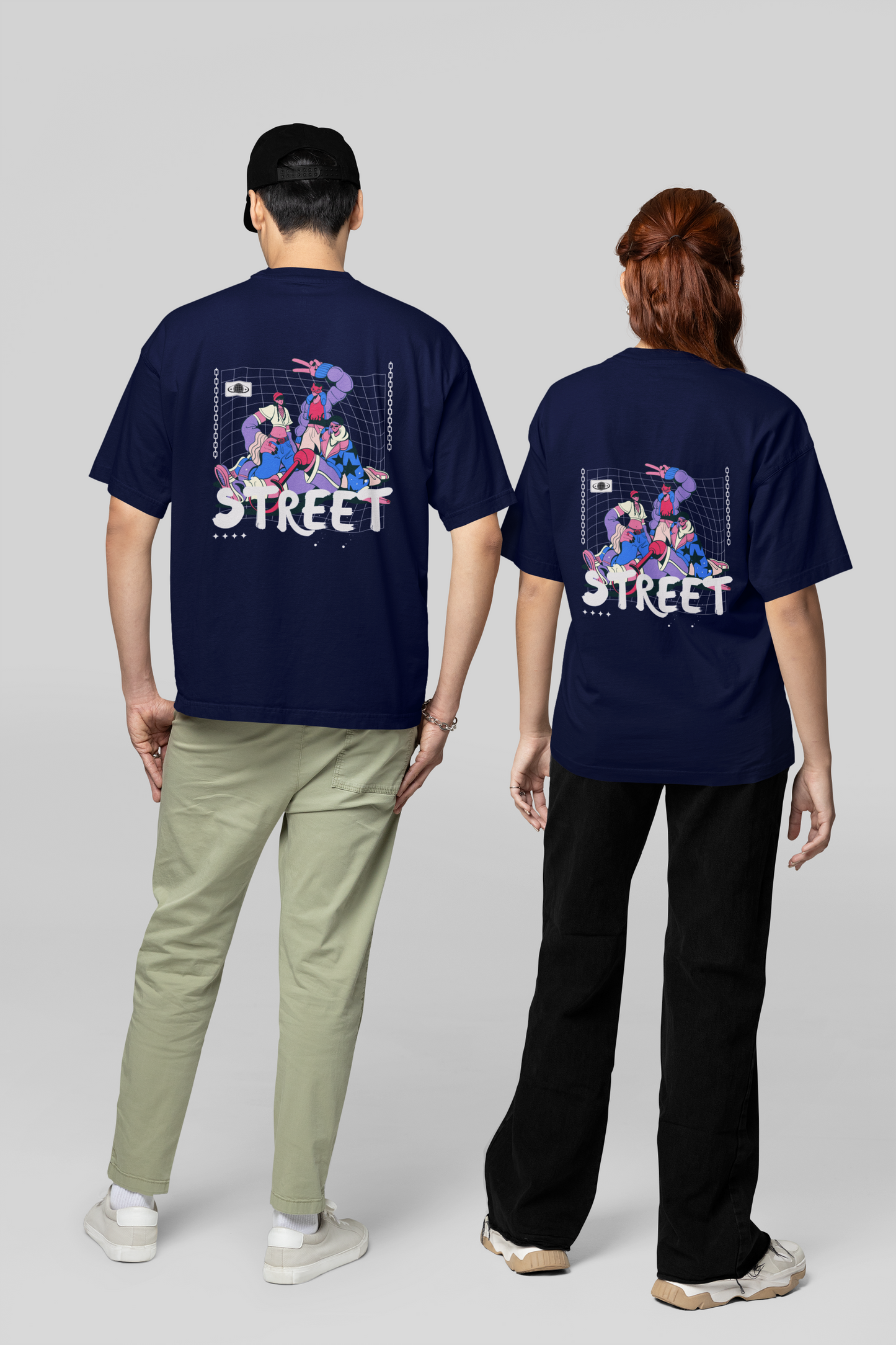 A couple dressed in navy blue oversized T-shirts featuring intricate Chinese typography and bold back graphics, ideal for coordinated streetwear looks on the streets.